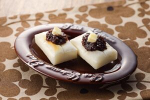 Toasted mochi topped with sweet red bean paste and a pat of butter